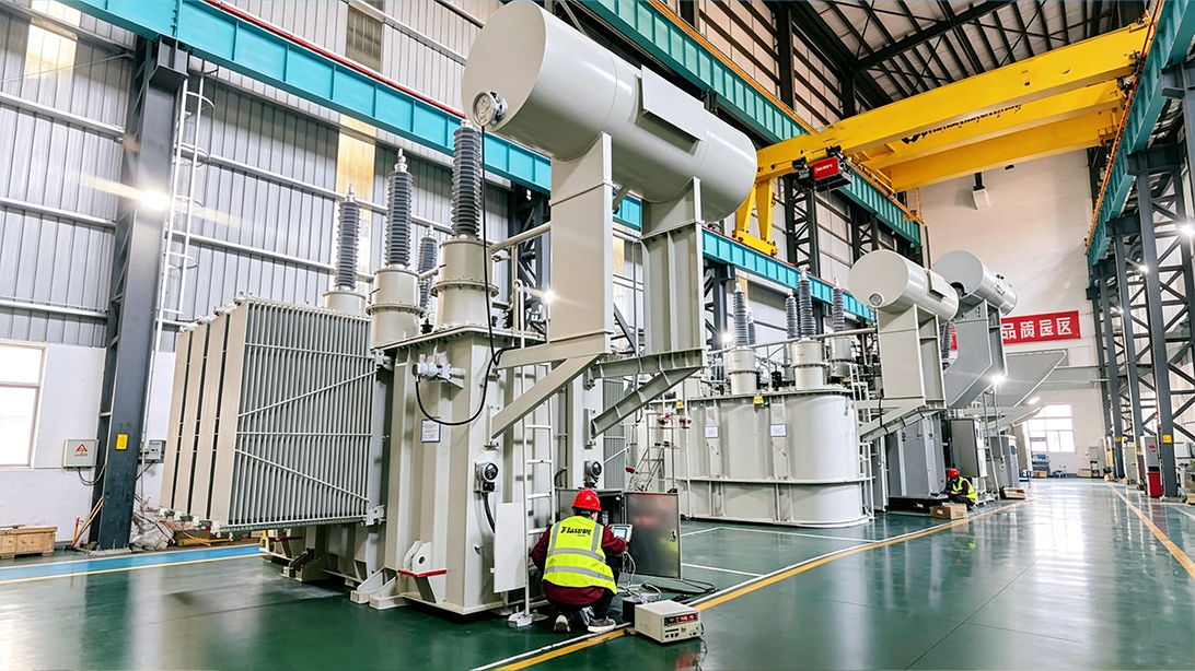 Technician with portable equipment beside oil-immersed transformers in a factory hall